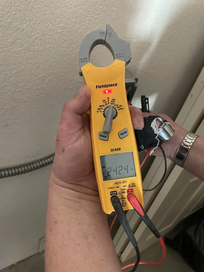 Voltage testing with clamp meter during Recessed Lighting Installation in Solon